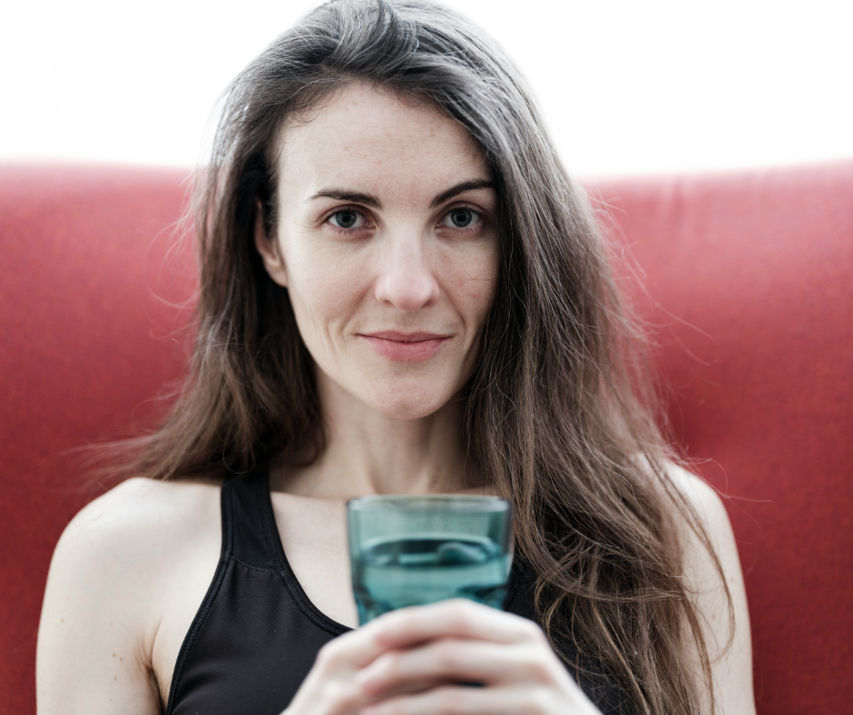 Healthy young woman drinks water