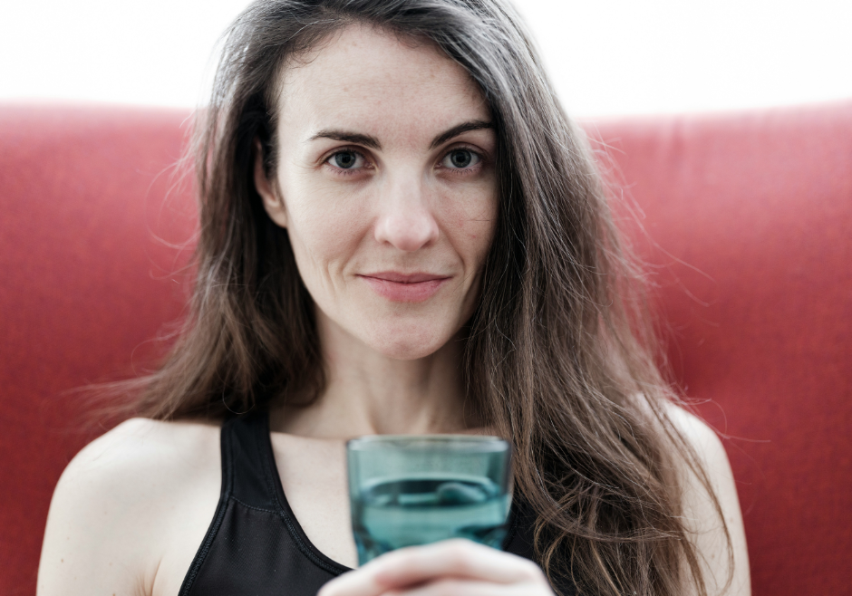 Healthy young woman drinks water