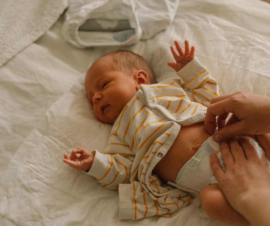 A newborn baby getting their diaper changed.